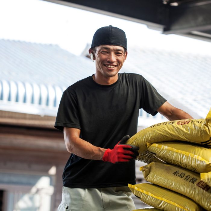 japanese-farmer-wearing-black-cap-standing-next-to-2023-11-27-04-57-35-utc.jpg